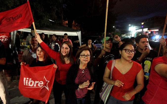 Opposition supporters dance and wave flags during a protest over a contested presidential election with allegations of electoral fraud in Tegucigalpa, Honduras, December 8, 2017.