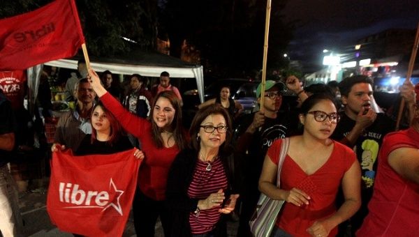 Opposition supporters dance and wave flags during a protest over a contested presidential election with allegations of electoral fraud in Tegucigalpa, Honduras, December 8, 2017. 