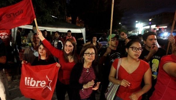 Opposition supporters dance and wave flags during a protest over a contested presidential election with allegations of electoral fraud in Tegucigalpa, Honduras, December 8, 2017.