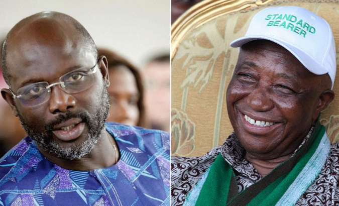 Liberian presidential candidates, soccer legend George Weah (L) and Vice President Joseph Boakai