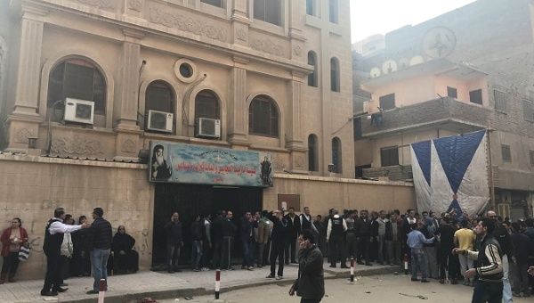 People are seen outside the Mar Mina Church after a blast, in Helwan district on the outskirts of Cairo, Egypt Dec. 29, 2017