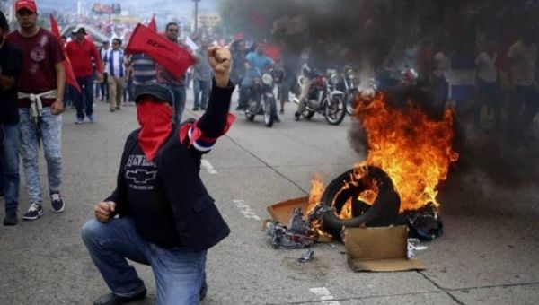 Hondurans protest the re-election of President Juan Orlando Hernandez.