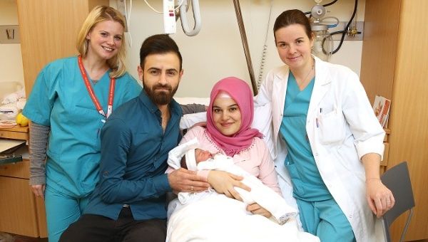Baby Asel and her parents with medical staff at a hospital in Vienna. 