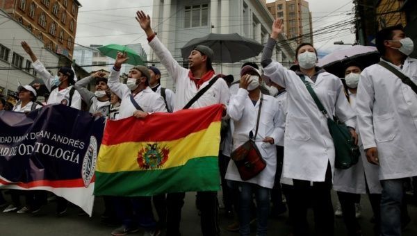 Demonstrators shout during a protest rally against Bolivia's government new health care policies in La Paz, Bolivia, Dec. 27, 2017.