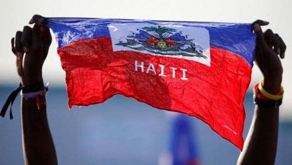 A girl holds national flag of Haiti before Pope Francis' arrival at the Campus Misericordiae during World Youth Day in Brzegi, near Krakow, Poland.