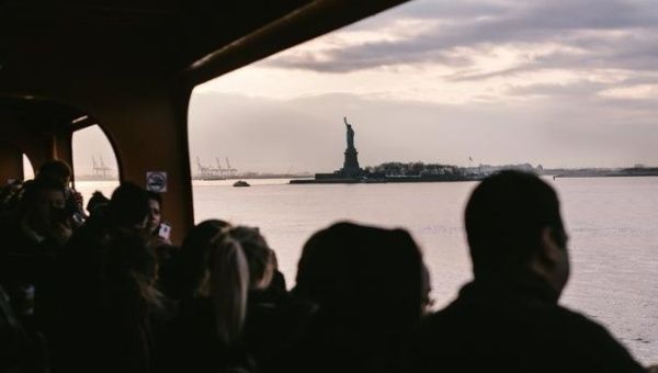 The Statue of Liberty can be seen through the windows of the Staten Island Ferry in New York, New York.
