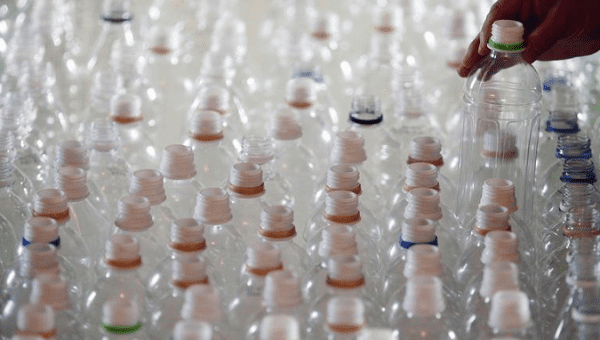 A worker picks up a plastic bottle before a news conference in Taipei November 4, 2009. 