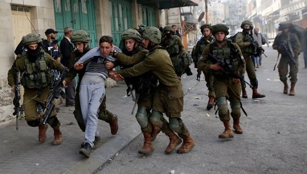 Israeli soldiers detain a Palestinian during clashes at a protest in Hebron, in the occupied West Bank.