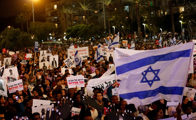 Pepole take part in a protest against the Israeli government's plan to deport African migrants, in Tel Aviv, Israel March 24, 2018.