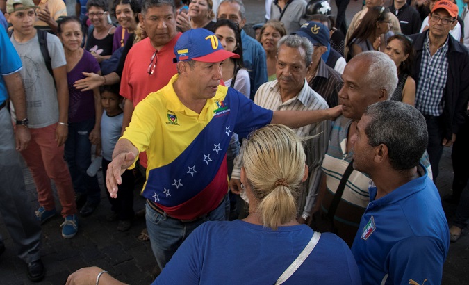 Venezuelan presidential candidate Henri Falcon speaks with people during a campaign event at the slum of Catia in Caracas, Venezuela April 2, 2018.