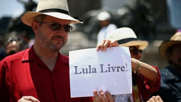 Demonstrators hold a sign that reads 