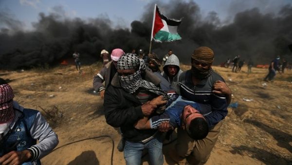 A wounded demonstrator is evacuated during protests at the Israel-Gaza border in the southern Gaza Strip, April 27, 2018. 