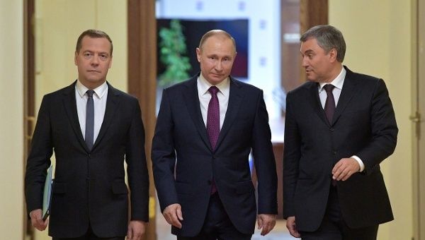 (L-R) Dmitry Medvedev, State Duma Speaker Vyacheslav Volodin, and President Vladimir Putin walk before a session of the State Duma.