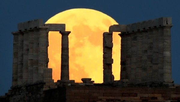 A full moon rises behind the Temple of Poseidon before a lunar eclipse in Cape Sounion, near Athens, Greece, July 27, 2018.