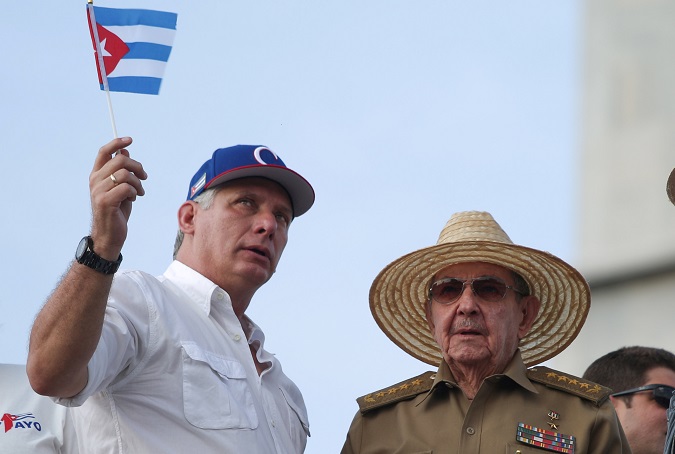Cuba's First Secretary of the Communist Party and former President Raul Castro (R), speaks to Cuba's President Miguel Diaz-Canel at a May Day rally in Havana, Cuba, May 1, 2018.