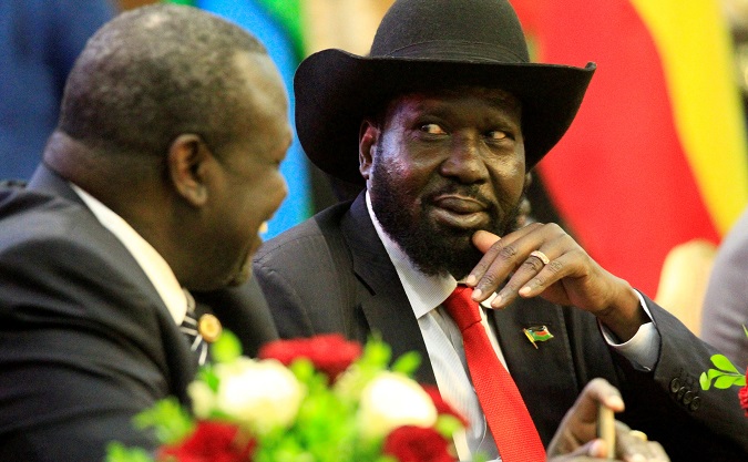 South Sudan's President Salva Kiir (R) talks to South Sudan's rebel leader Riek Machar as they sign a cease fire and power sharing agreement with in Khartoum, Sudan August 5, 2018.