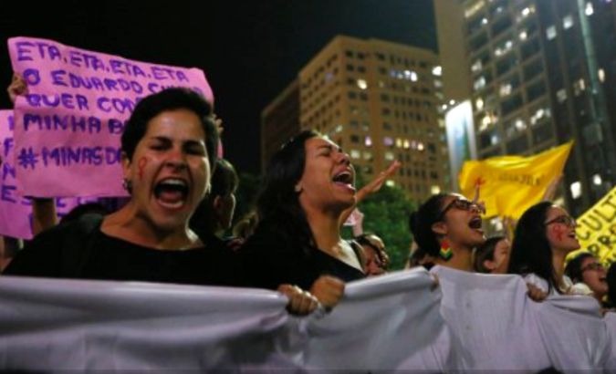 Demonstrators attend a protest against rape and violence against women in Rio de Janeiro.