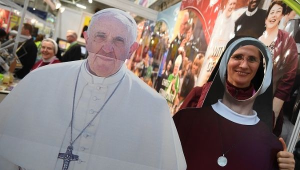 A nun poses behind cardboard cut-outs of Pope Frances and a nun at the Pastoral Congress at the World Meeting of Families in Dublin, Ireland August 23, 2018.