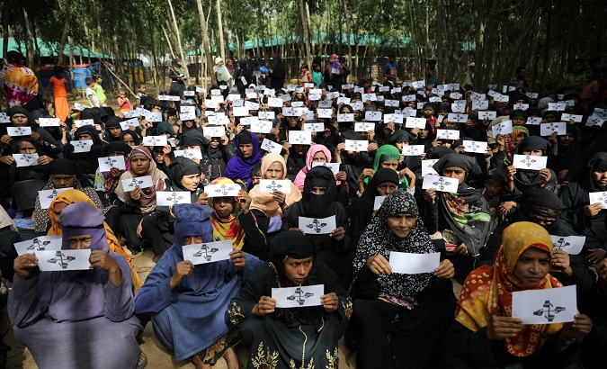 Women refugees demonstrate to demand justice for Myanmar's state violence.