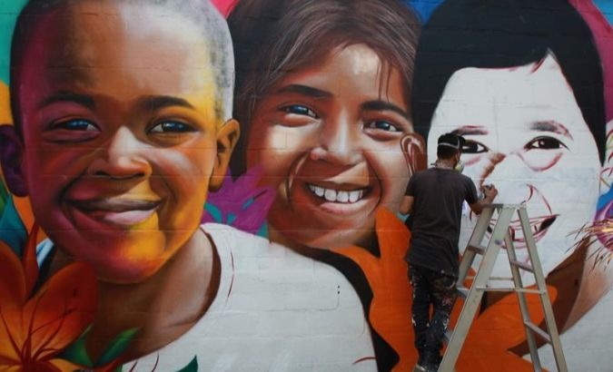 An artist paints a mural in La Paz, Bolivia.