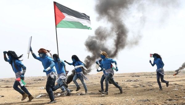 Palestinians with their faces painted like characters from the movie Avatar take part in a protest at the Israel-Gaza border in the southern Gaza Strip.
