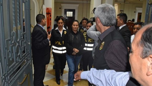 Opposition leader Keiko Fujimori is escorted by police officers after the judge ordered her back to jail pending a trial over allegations she used her conservative party to launder money for Brazilian construction company Odebrecht in Lima