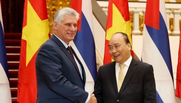 Cuba President Miguel Diaz-Canel (L) shakes hands with Vietnam Prime Minister Nguyen Xuan Phuc at the government office in Hanoi, Vietnam in Nov. 9.