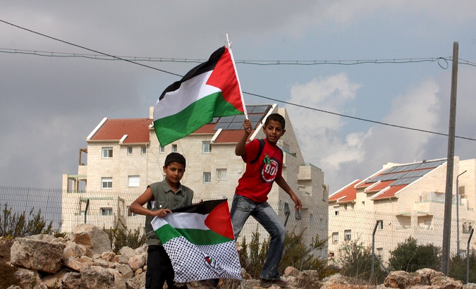 Palestinian children wave their flag in the occupied city of Bethlehem.