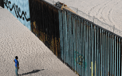 Central American Exodus member, migrant caravan looks at the border fence between Mexico and the US in Tijuana, Mexico November 15, 2018. 