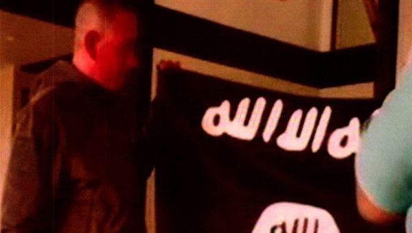  Kang holding the Islamic State Flag after pledging allegiance to the Islamic State. Kang is charged with trying to provide material support to Islamic State extremists.