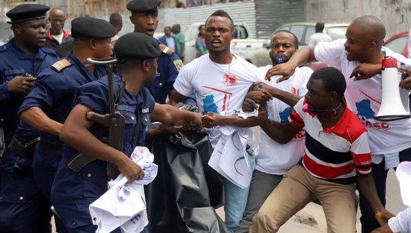 Congolese police officers attempt to disperse members of the CASC chanting slogans as they protest to demand free fair elections in Kinshasa