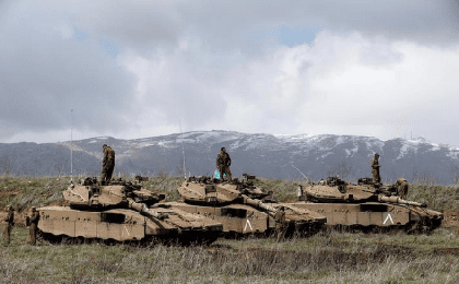 Israeli soldiers stand atop tanks in the Golan Heights near Israel's border with Syria March 19, 2014
