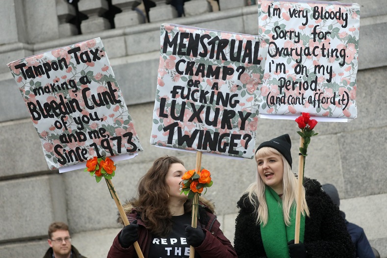 Protesters hold up signs in the Women's March calling for equality, justice and an end to austerity in London, Britain 