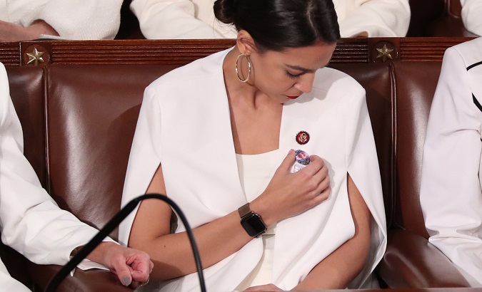 Alexandria Ocasio-Cortez pointing at her button of Jakelin Caal, the migrant child who died at the U.S. border custody.