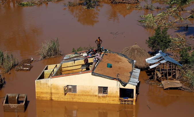 A man looks on atop his house after Cyclone Idai in Buzi district outside Beira, Mozambique, March 22, 2019.