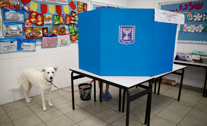 Dog stands by as owner votes in Israeli Knesset elections. April 9, 2019