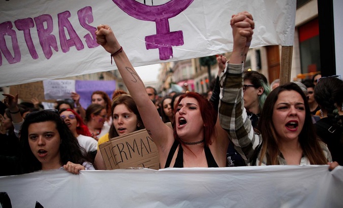 People shout slogans during a protest after a Spanish court condemned five men accused of the gang rape of an 18-year-old woman, in Malaga, Spain, April 26, 2018.