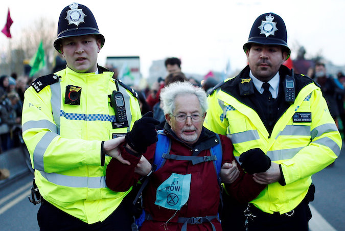 Police detain a protester as climate change activists demonstrate during a Extinction Rebellion protest at the Waterloo Bridge in London, Britain April 15, 2019.