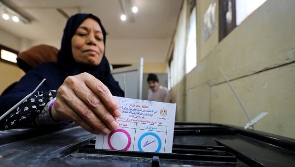 A woman casts her vote during the referendum on draft constitutional amendments, at a polling station in Cairo, Egypt April 20, 2019