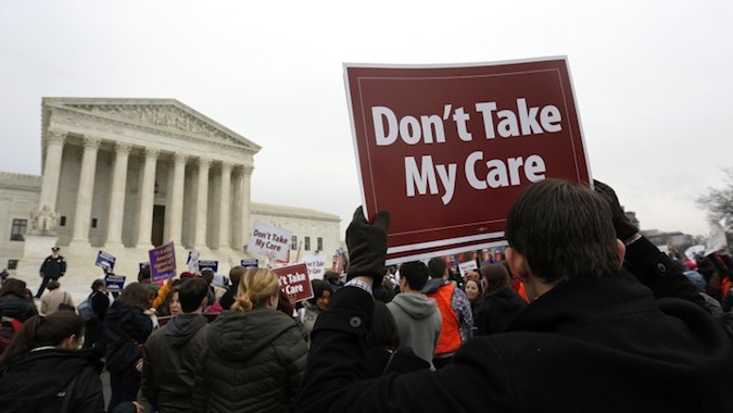 Demonstrators in favor of Obamacare gather at the Supreme Court building in Washington, D.C.