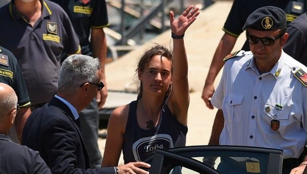 Carola Rackete, the 31-year-old Sea-Watch 3 captain, disembarks from a Finance police boat and is escorted to a car, in Porto Empedocle, Italy July 1, 2019.