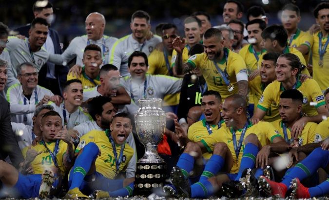 Brazil players celebrate winning the Copa America with the trophy.