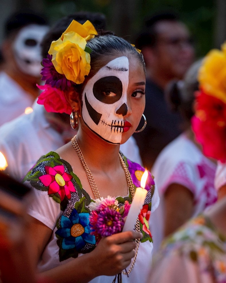 Young woman holds a candle during the Hanal Pixan celebrations at the Lerona Vicario town, Quintana Roo, Mexico, Oct. 31, 2019.