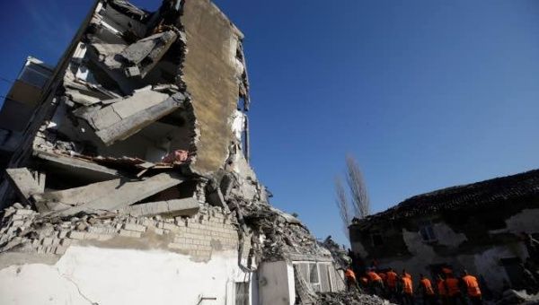 Emergency personnel work near a damaged building in Thumane, after an earthquake shook Albania, November 26, 2019