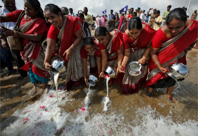 Women pour milk into the waters of the Bay of Bengal during a prayer ceremony for the victims of the 2004 tsunami on the 15th anniversary of the disaster, at Marina beach in Chennai, India, December 26, 2019.