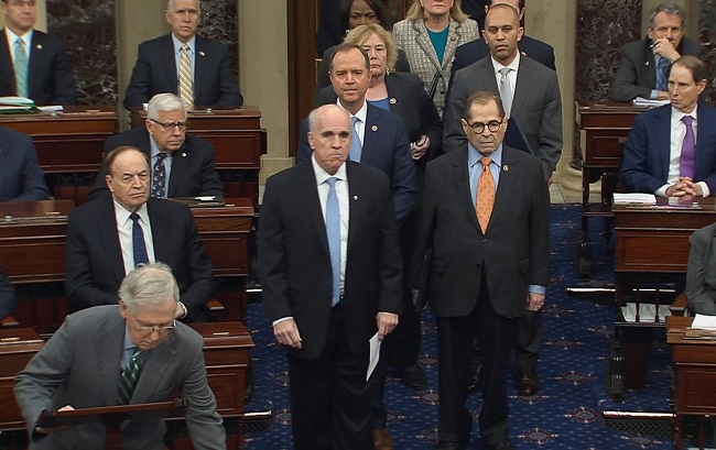 The U.S. Senate Sergeant at Arms Michael Stenger escorts the U.S. House impeachment managers, including lead manager House Intelligence Committee Chairman Adam Schiff (D-CA); House Judiciary Committee Chairman Jerrold Nadler (D-NY); House Democratic Caucus Chairman Hakeem Jeffries (D-NY) and Rep. Zoe Lofgren (D-CA) onto the floor of the Senate behind Senate Majority Leader Mitch McConnell as they arrive for the procedural start of the Senate impeachment trial of U.S. President Donald Trump in this frame grab from video shot at the U.S. Capitol in Washington, U.S., January 16, 2020.