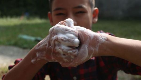 Nepalese kid washing his hands