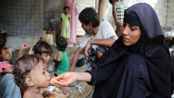 A woman feeds her child at a shelter in civil war-torn Yemen, March, 2020.