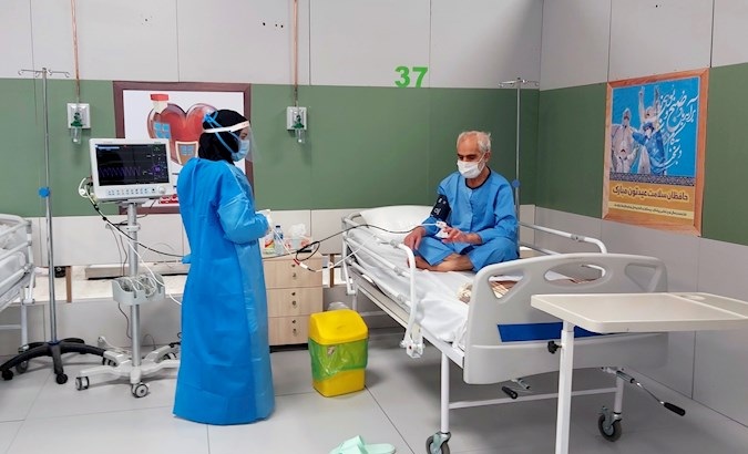 A nurse cares for a COVID-19 patient at the hospital installed at Iran Mall, Tehran, Iran, March 30, 2020.