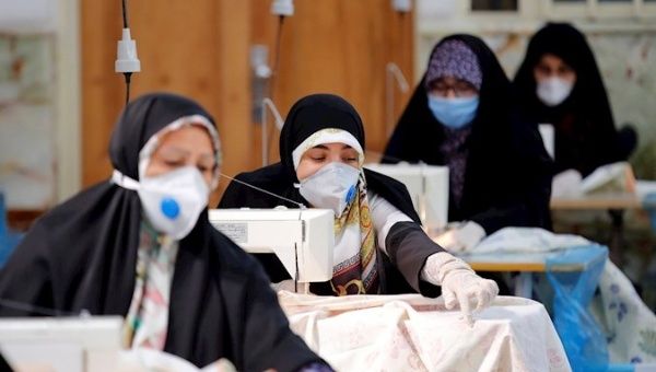 Women make face masks at a mosque in the Qasem shrine in Tehran, Iran, April 5, 2020.
